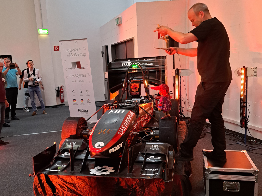 The new racing car with its namesake from the Augsburg Puppet Show: The Red Goblin. 